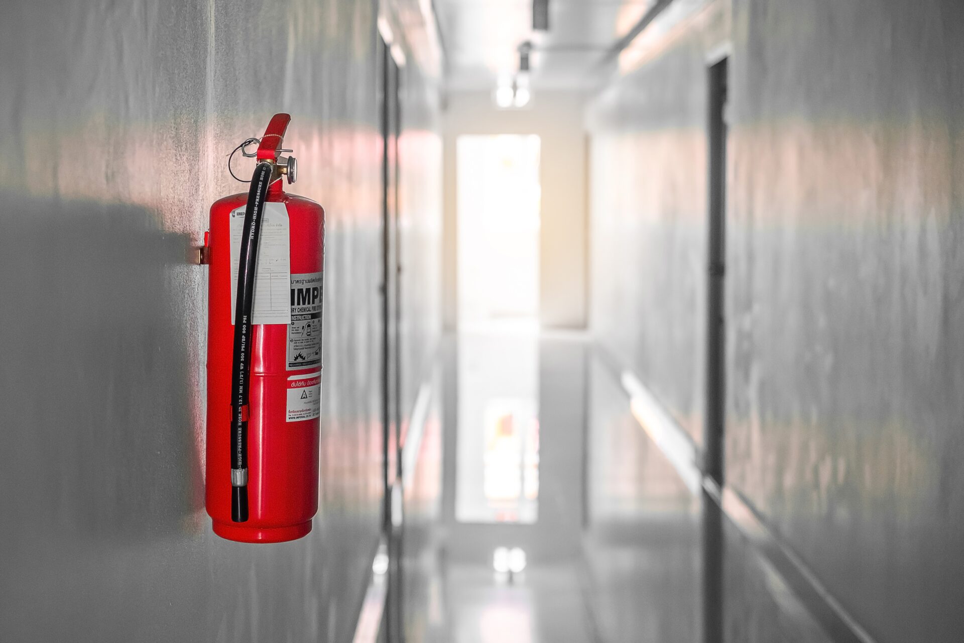 Quality Fire extinguisher on the wall background, powerful emergency equipment for industrial